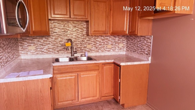 3145 Bernice Rd Unit 4, Lansing, IL 60438 - kitchen featuring stainless steel microwave, a sink, light countertops, and decorative backsplash