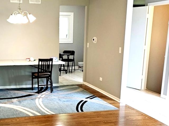 1602 Nightengale Cir, Lindenhurst, IL 60046 - foyer featuring a chandelier, wood finished floors, and baseboards