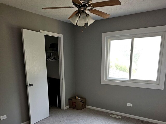 1602 Nightengale Cir, Lindenhurst, IL 60046 - unfurnished bedroom with carpet floors, a closet, a textured ceiling, ceiling fan, and baseboards