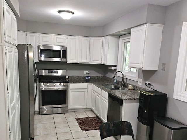 1602 Nightengale Cir, Lindenhurst, IL 60046 - kitchen featuring appliances with stainless steel finishes, a sink, light tile patterned floors, and white cabinetry