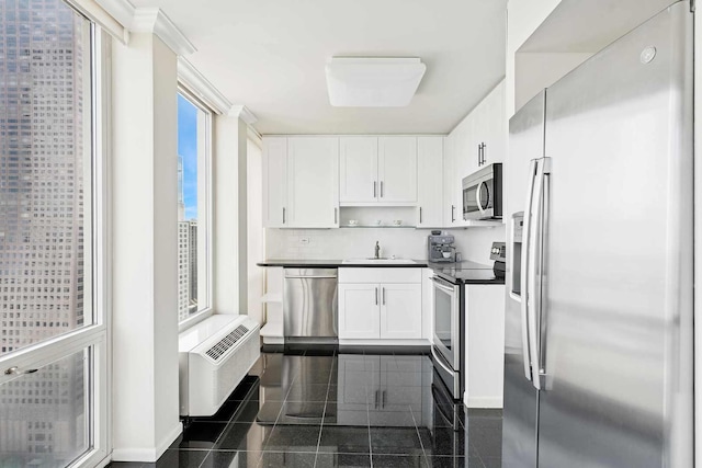 111 E Chestnut St Unit 39C, Chicago, IL 60611 - kitchen with stainless steel appliances, granite tiled floors, a sink, dark countertops, and white cabinetry