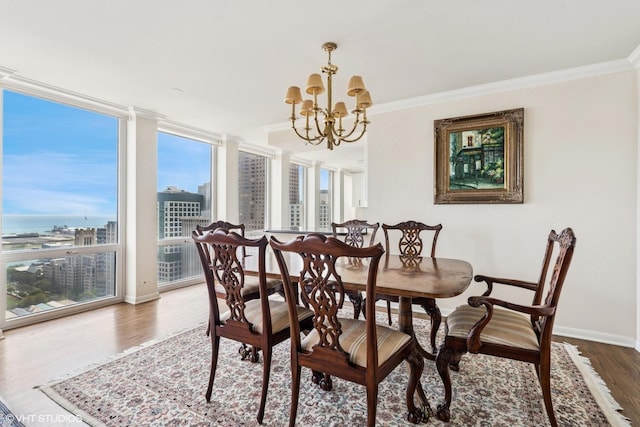 111 E Chestnut St Unit 39C, Chicago, IL 60611 - dining room featuring a chandelier, wood finished floors, ornamental molding, baseboards, and a city view