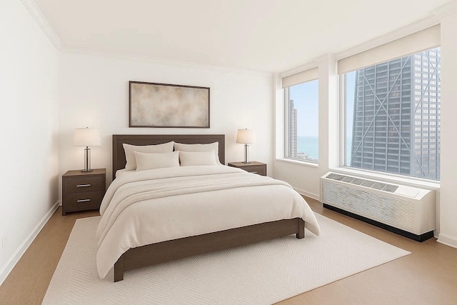 111 E Chestnut St Unit 39C, Chicago, IL 60611 - bedroom featuring baseboards, a wall mounted AC, and ornamental molding