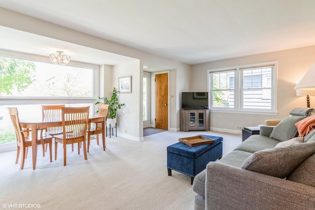 carpeted living area with baseboards