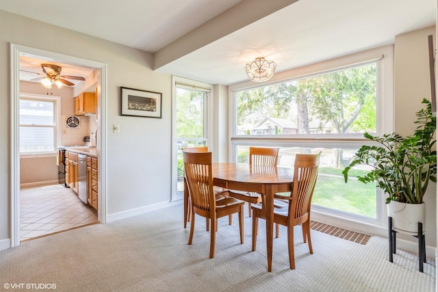 dining area featuring light carpet, baseboards, and ceiling fan