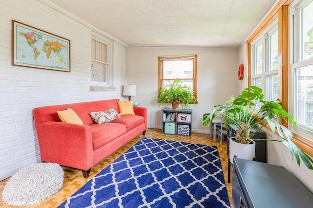living area featuring brick wall