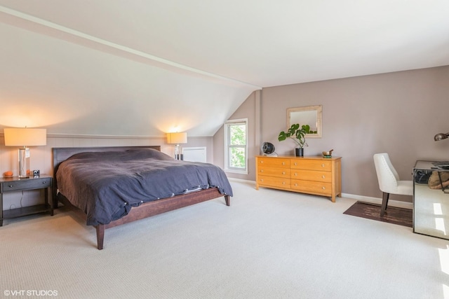 bedroom featuring carpet floors, vaulted ceiling, and baseboards