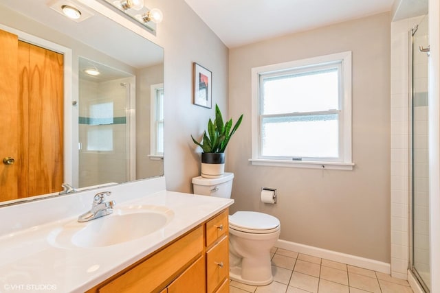 full bathroom featuring vanity, toilet, tile patterned flooring, a tile shower, and baseboards