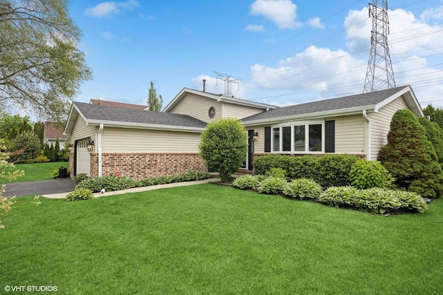 269 Cascade Dr, Crystal Lake, IL 60012 - split level home featuring a front yard, a garage, brick siding, driveway, and roof with shingles