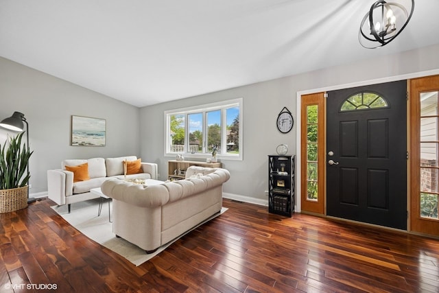 269 Cascade Dr, Crystal Lake, IL 60012 - living area featuring dark wood-style flooring, a chandelier, healthy amount of natural light, lofted ceiling, and baseboards