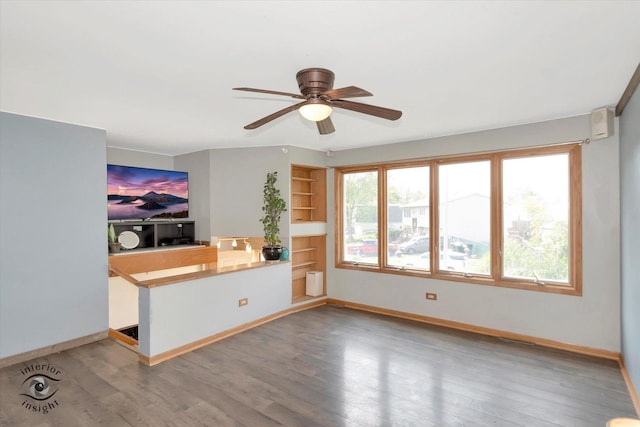 7707 Bristol Ln, Tinley Park, IL 60477 - unfurnished living room with ceiling fan, wood finished floors, baseboards, and built in shelves