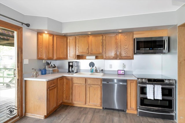 7707 Bristol Ln, Tinley Park, IL 60477 - kitchen featuring stainless steel appliances, a sink, wood finished floors, light countertops, and brown cabinetry