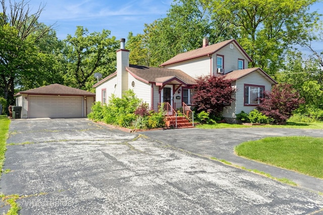 110 E Main St, Glenwood, IL 60425 - view of front of house with a garage, a chimney, an outdoor structure, and roof with shingles