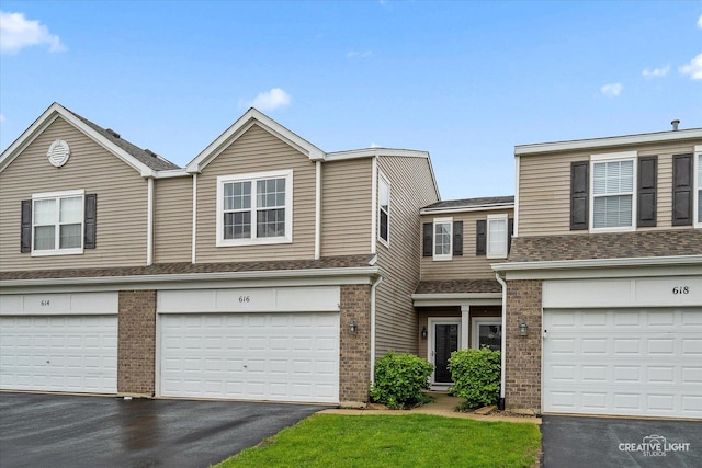 616 Springbrook Trl N, Oswego, IL 60543 - multi unit property with driveway, brick siding, an attached garage, and a shingled roof