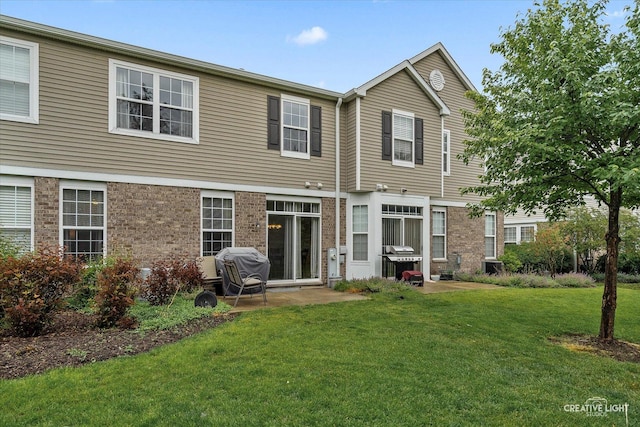 616 Springbrook Trl N, Oswego, IL 60543 - back of house featuring a lawn and brick siding