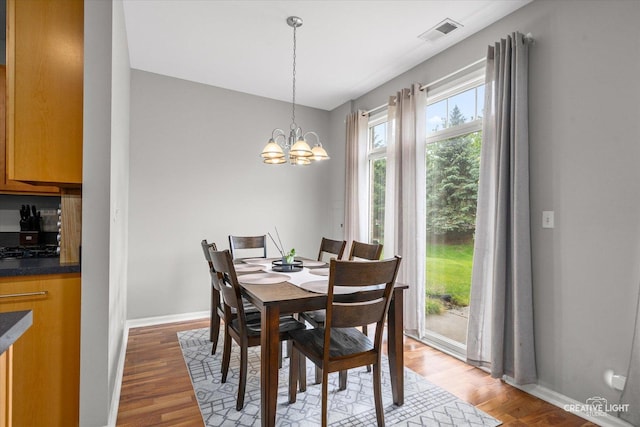 616 Springbrook Trl N, Oswego, IL 60543 - dining area with light wood-style flooring, a chandelier, and baseboards
