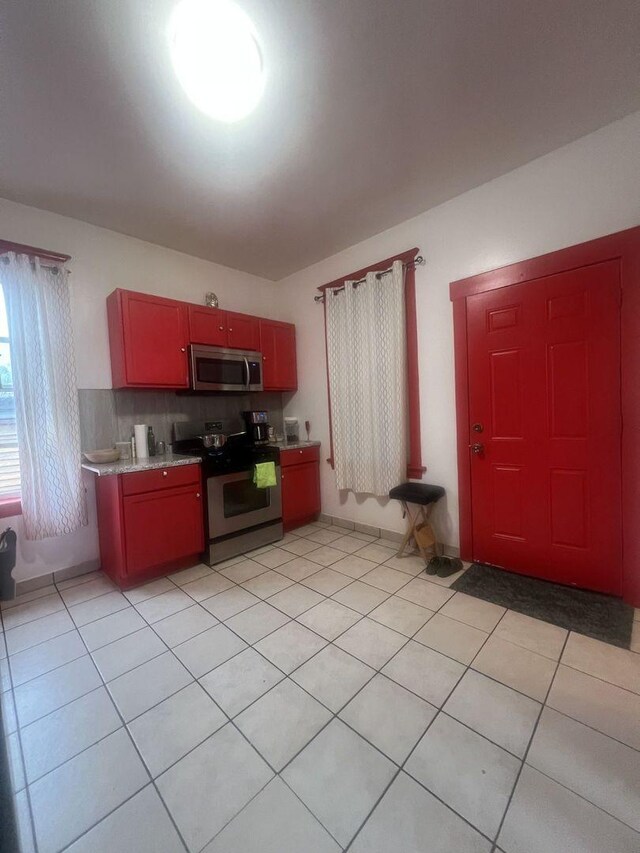3945 W Augusta Blvd, Chicago, IL 60651 - kitchen featuring stainless steel appliances, light tile patterned floors, and light countertops