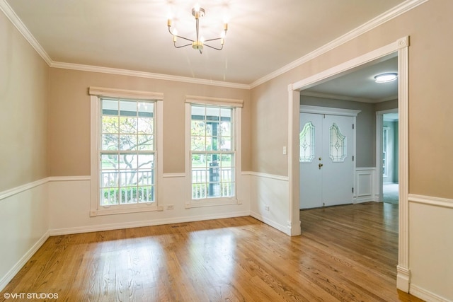 1921 E Peachtree Ln, Arlington Heights, IL 60004 - unfurnished dining area featuring a chandelier, wood finished floors, a wainscoted wall, and ornamental molding