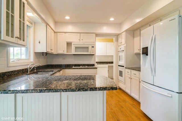 1921 E Peachtree Ln, Arlington Heights, IL 60004 - kitchen featuring white appliances, a sink, a peninsula, light wood finished floors, and glass insert cabinets