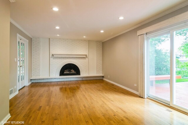 1921 E Peachtree Ln, Arlington Heights, IL 60004 - unfurnished living room with ornamental molding, wood finished floors, baseboards, recessed lighting, and a brick fireplace
