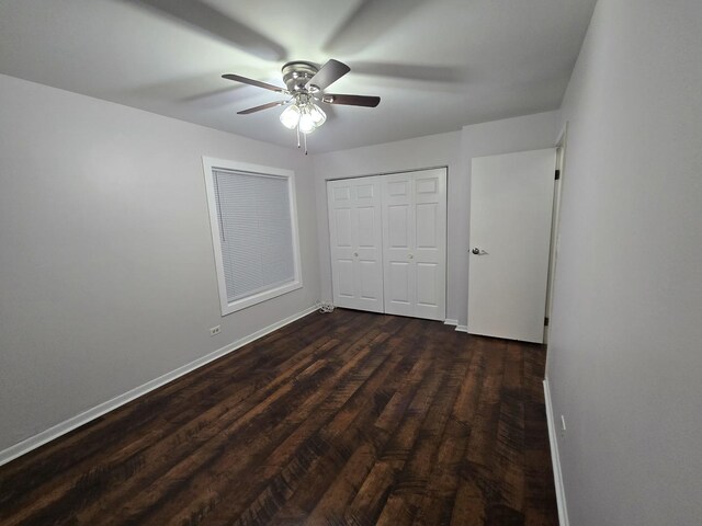 460 74th St Unit 102, Downers Grove, IL 60516 - unfurnished bedroom with baseboards, dark wood-style floors, a closet, and a ceiling fan