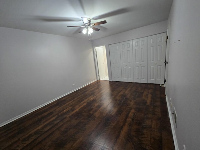 460 74th St Unit 102, Downers Grove, IL 60516 - unfurnished bedroom with dark wood-style floors, baseboards, a ceiling fan, and a closet