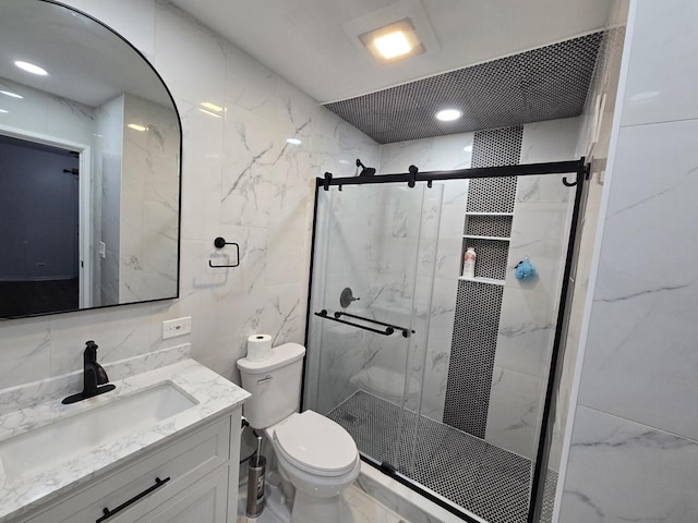 460 74th St Unit 102, Downers Grove, IL 60516 - bathroom with vanity, toilet, a marble finish shower, tile walls, and marble finish floors