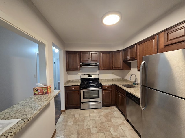 460 74th St Unit 102, Downers Grove, IL 60516 - kitchen featuring appliances with stainless steel finishes, exhaust hood, a sink, stone finish floors, and dark brown cabinets