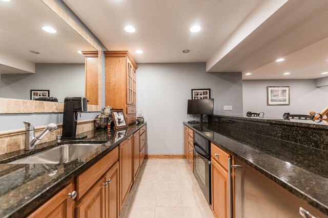 1607 Park Point, Ridge Point, Park Ridge, IL 60068 - kitchen featuring oven, recessed lighting, dark stone countertops, a sink, and baseboards