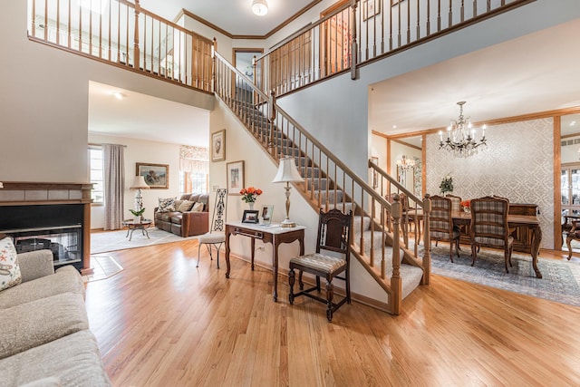 1607 Park Point, Ridge Point, Park Ridge, IL 60068 - staircase with wood finished floors, a high ceiling, crown molding, baseboards, and wallpapered walls