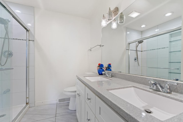 419 Glenshire Rd, Glenview, IL 60025 - bathroom featuring a shower stall, toilet, double vanity, and recessed lighting
