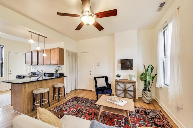 1954 W George St Unit 2, Chicago, IL 60657 - living area with light wood-style floors, ceiling fan, and baseboards