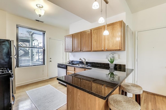 1954 W George St Unit 2, Chicago, IL 60657 - kitchen featuring a sink, a kitchen bar, a peninsula, appliances with stainless steel finishes, and dark stone countertops