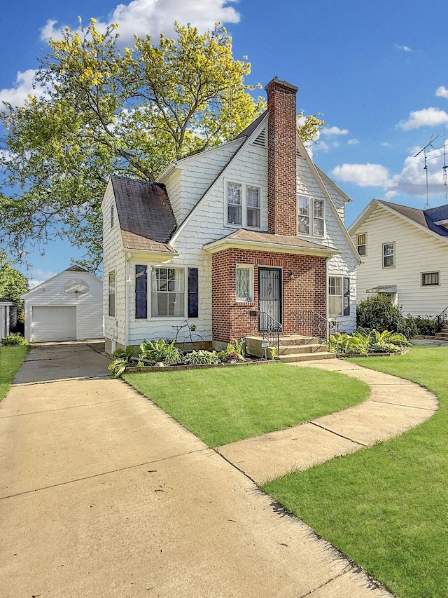1351 W Stover St, Freeport, IL 61032 - dutch colonial with a garage, a chimney, concrete driveway, a front lawn, and an outbuilding