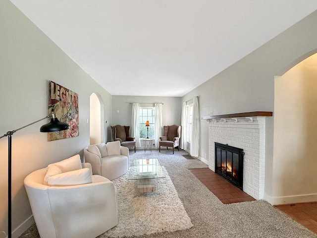 1351 W Stover St, Freeport, IL 61032 - living room featuring arched walkways, baseboards, and a fireplace