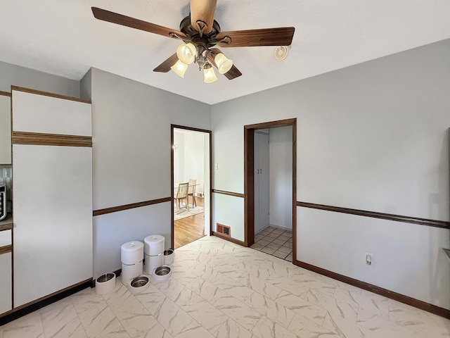 1351 W Stover St, Freeport, IL 61032 - unfurnished bedroom with light marble finish flooring, a ceiling fan, and a closet