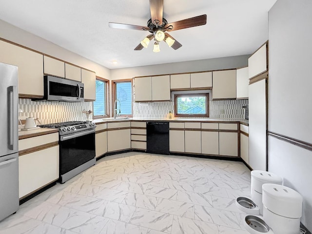 1351 W Stover St, Freeport, IL 61032 - kitchen featuring stainless steel appliances, light marble finish floors, ceiling fan, and a sink