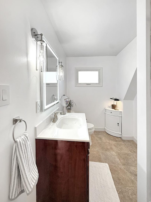1351 W Stover St, Freeport, IL 61032 - bathroom with vanity, toilet, and baseboards
