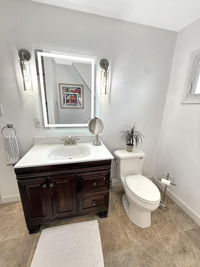1351 W Stover St, Freeport, IL 61032 - bathroom featuring toilet, vanity, baseboards, and tile patterned flooring