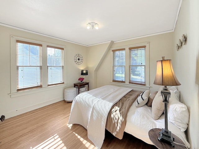 1351 W Stover St, Freeport, IL 61032 - bedroom with multiple windows, wood finished floors, ornamental molding, and baseboards