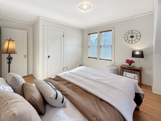 1351 W Stover St, Freeport, IL 61032 - bedroom with light wood-style floors, baseboards, ornamental molding, and a closet