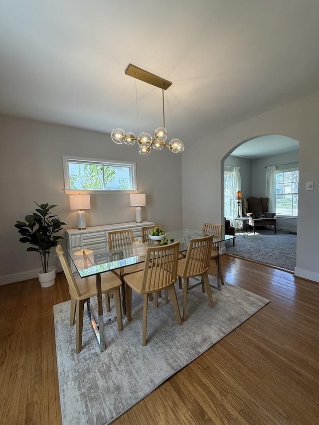 1351 W Stover St, Freeport, IL 61032 - dining area featuring arched walkways, wood finished floors, and baseboards