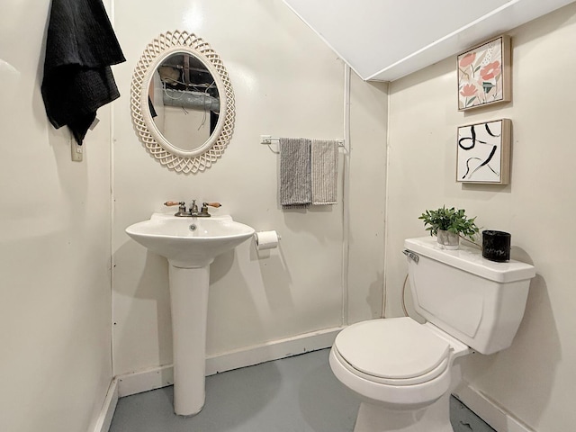 1351 W Stover St, Freeport, IL 61032 - half bath featuring toilet, concrete flooring, baseboards, and a sink