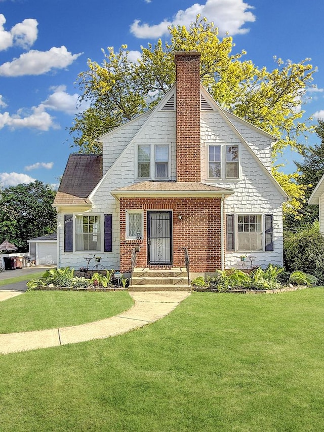 1351 W Stover St, Freeport, IL 61032 - view of front facade featuring a chimney and a front lawn