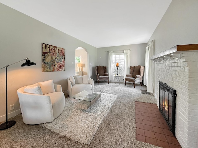 1351 W Stover St, Freeport, IL 61032 - living room with carpet, arched walkways, and a brick fireplace