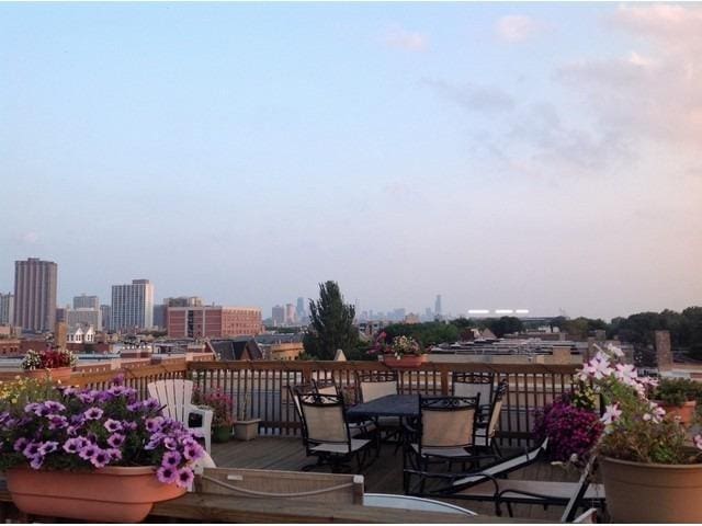 4150 N Kenmore Ave Unit 206, Chicago, IL 60613 - wooden terrace with a view of skyline and outdoor dining area