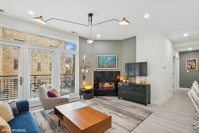 4150 N Kenmore Ave Unit 206, Chicago, IL 60613 - living area with wood finished floors, a warm lit fireplace, recessed lighting, and baseboards