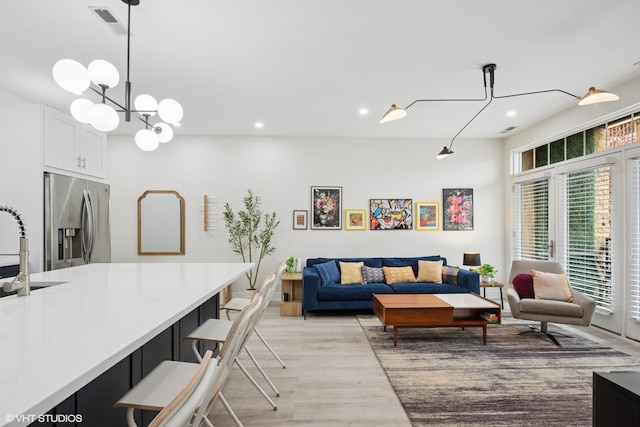 4150 N Kenmore Ave Unit 206, Chicago, IL 60613 - living area with light wood finished floors, recessed lighting, and a chandelier