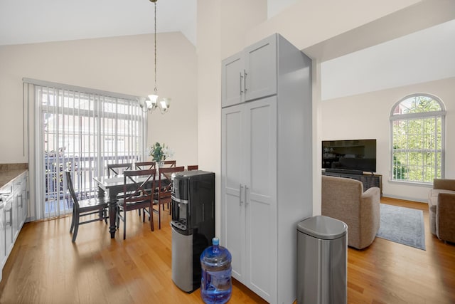 679 Prestwick Ln, Wheeling, IL 60090 - dining area with light wood-style floors, a chandelier, and high vaulted ceiling