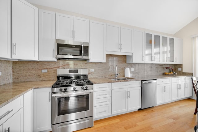 679 Prestwick Ln, Wheeling, IL 60090 - kitchen with stainless steel appliances, a sink, white cabinets, and light wood-style flooring